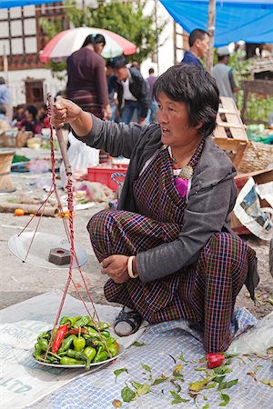 Weighing chillies at Paro weekly open-air vegetable market. Stock Photo - Rights-Managed, Code: 862-05996907