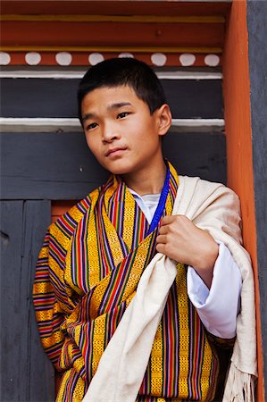 Young boy watching the masked dancing at Trashi Chhoe Dzong, a monastery now also housing the secretariat, the throne room and offices of the King. Stock Photo - Rights-Managed, Code: 862-05996918