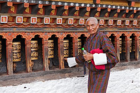 Turning the beautiful black and gold prayer wheels at Changangkha Lhakhang, where parents come to obtain auspicious names for their newborns. Stock Photo - Rights-Managed, Code: 862-05996925