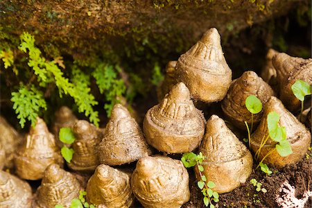 simsearch:862-05996927,k - Small sculpture stupa images (tsha tsha) made of clay containing ashes of the dead, placed under rocks en route to Tango Goemba. Stock Photo - Rights-Managed, Code: 862-05996931