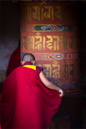 simsearch:862-05996927,k - Monk circumambulating a large prayer wheel at the beautiful 7th century Jampey Lhakhang, near Jakar in the Chokhor Valley. Stock Photo - Rights-Managed, Code: 862-05997005