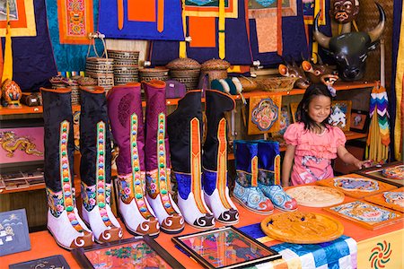 embroidery - Traditional knee-length boots known as Tsholham, worn by Bhutanese men during important ceremonial occasions, for sale in a shop in Thimphu. Stock Photo - Rights-Managed, Code: 862-05997050