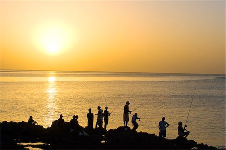 fish on fishing rods - The Caribbean, West Indies, Cuba, Havana, The Malecon, people fishing at sunset Stock Photo - Rights-Managed, Code: 862-05997394