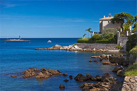 french riviera architecture - Antibes, Provence-Alpes-Cote d'Azur, France. Luxury residence near Pointe Bacon and the La Grand Grenille island in the background Stock Photo - Rights-Managed, Code: 862-05997644