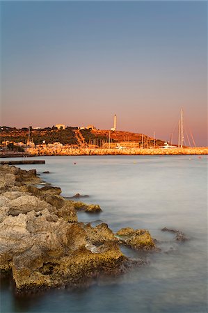 salento - Italy, Apulia, Lecce district, Salentine Peninsula, Salento, Santa Maria di Leuca, View of the town's headland with the sanctuary and the lighthouse as seen from the harbour area Fotografie stock - Rights-Managed, Codice: 862-05997978