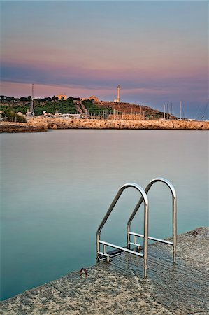 salento - Italy, Apulia, Lecce district, Salentine Peninsula, Salento, Santa Maria di Leuca, View of the town's headland with the sanctuary and the lighthouse as seen from the harbour area Fotografie stock - Rights-Managed, Codice: 862-05997970