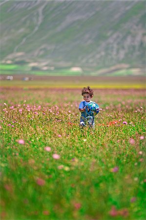 Italy, Umbria, Perugia district, Monti Sibillini NP, Norcia, Pian Grande, baby plays with ball. Stock Photo - Rights-Managed, Code: 862-05998113