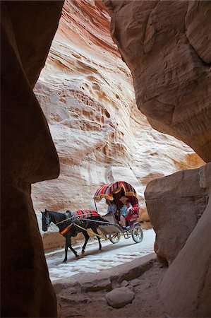 Horse drawn carriage travelling through The Siq, a narrow canyon passage leading to The Treasuary, Petra Stock Photo - Rights-Managed, Code: 862-05998318