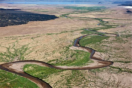 simsearch:862-05998435,k - The highly alkaline Suguta River meanders through the low-lying, inhospitable Suguta Valley to discharge its waters into Lake Logipi whose size varies seasonally. Stock Photo - Rights-Managed, Code: 862-05998433