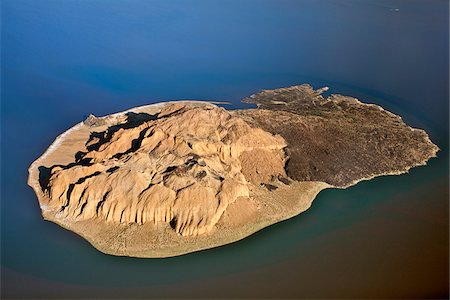 simsearch:862-03888751,k - The small volcanic island, known as Cathedral Rock, is surrounded by the highly alkaline waters of seasonal Lake Logipi in the inhospitable, low-lying Suguta Valley. Stock Photo - Rights-Managed, Code: 862-05998446
