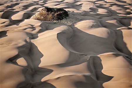 simsearch:862-05998435,k - Sand dunes surround a black lava outcrop in the hospitable, low-lying Suguta Valley of northern Kenya. Stock Photo - Rights-Managed, Code: 862-05998458