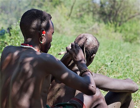 ritual - Towards the end of a Sapana ceremony,  the initiate will have his hair styled in a traditional clay bun. Stock Photo - Rights-Managed, Code: 862-05998507