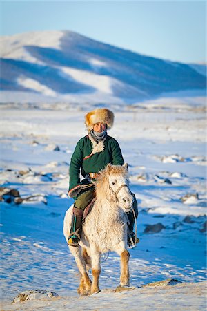 pony - Mongolia, Ovorkhangai, Orkkhon Valley. A man approaches on horseback at sunrise. Stock Photo - Rights-Managed, Code: 862-05998640