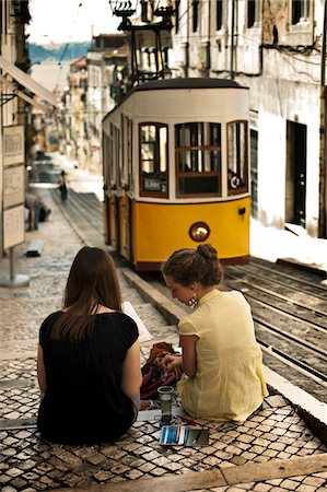 portugal - Portugal, Distrito de Lisboa, Lisbon, Bairro Alto, two young girl painting the tram of elevador da Bica, Stock Photo - Rights-Managed, Code: 862-05998862