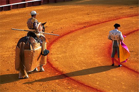 plaza de toros de la real - Spain, Andalusia, Seville; A picador and a toreador observing the movements of the bull during a 'Corrida' in 'La Meastranza' bull ring - the oldest arena of the sort in the world Stock Photo - Rights-Managed, Code: 862-05999160