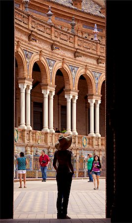 people of seville spain - Spain, Andalusia, Seville; A tourist looking on the Plaza de Espana. Stock Photo - Rights-Managed, Code: 862-05999206