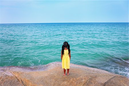 simsearch:862-05999536,k - Thailand, Ko Samui, Chaweng beach, Girl standing on rock looking out to sea Stock Photo - Rights-Managed, Code: 862-05999534