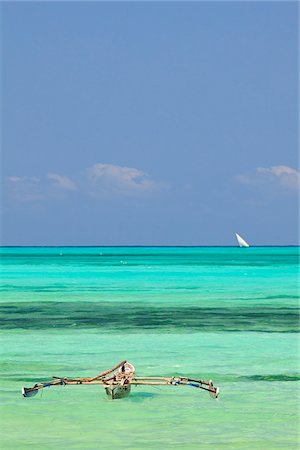 Tanzania, Zanzibar, Unguja, Jambiani. A traditional dhow moored near the shore. Stock Photo - Rights-Managed, Code: 862-05999580