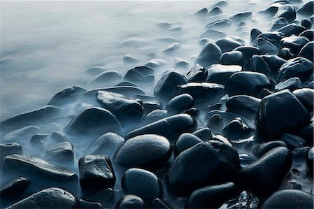 Australia, Queensland, Cairns.  Waves lapping rocks at Pebbly Beach. Stock Photo - Rights-Managed, Code: 862-06540767