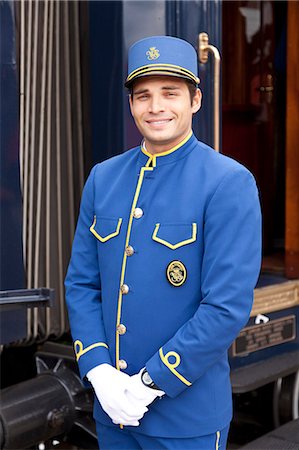 fattorino d'albergo - A steward in his very smart uniform on the Venice Simplon Orient Express train, Innsbruck, Austria Fotografie stock - Rights-Managed, Codice: 862-06540771