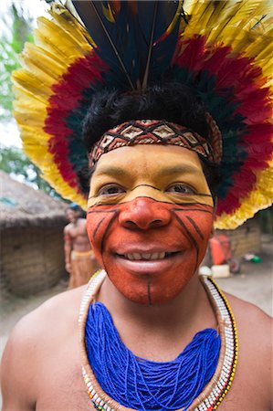 south american headdress feather - Brazil, Bahia, Porto Seguro, Pataxo indigenous man wearing a feather headdress in the Jaqueira Pataxo Reservation Stock Photo - Rights-Managed, Code: 862-06540804