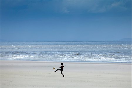 South America, Brazil, Maranhao, Sao Luis, Sao Marcos beach, boy playing football on the beach Stock Photo - Rights-Managed, Code: 862-06540892