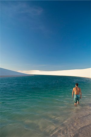 South America, Brazil, Maranhao, a swimmer enters a lake surrounded by dunes in the Lencois Maranhenses Stock Photo - Rights-Managed, Code: 862-06540926