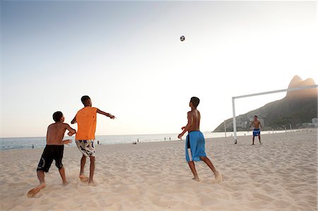 South America, Rio de Janeiro, Rio de Janeiro city, Ipanema, boys playing football on Ipanema beach in front of the Dois Irmaos mountains Stock Photo - Rights-Managed, Code: 862-06540970