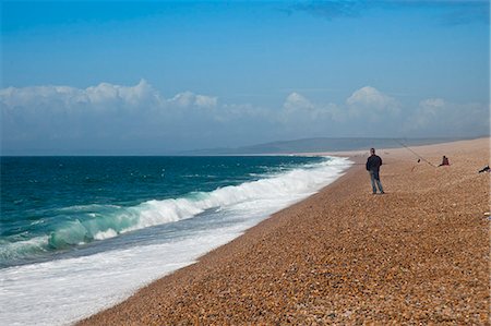 Dorset, England,  A man fishing on Chesil beach which is over 18 miles long. Foto de stock - Con derechos protegidos, Código: 862-06541376