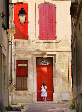 France, Provence, Arles, girl with Baguette at red doorway MR Stockbilder - Lizenzpflichtiges, Bildnummer: 862-06541489