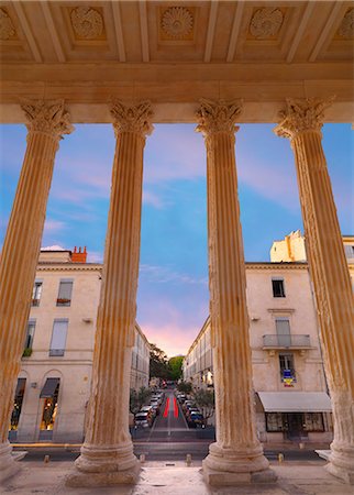 simsearch:862-06541539,k - France, Provence, Nimes, Maison Caree, view through columns at dusk Stock Photo - Rights-Managed, Code: 862-06541547