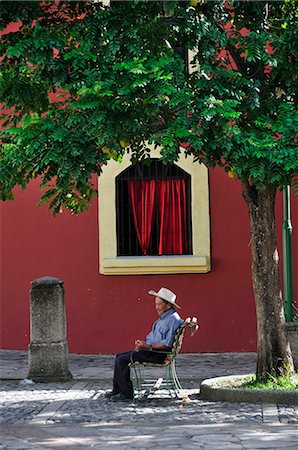 Elderly man sat in Plaza at Iglesia de la Merced, Comayagua, Central America, Honduras. Stock Photo - Rights-Managed, Code: 862-06541892