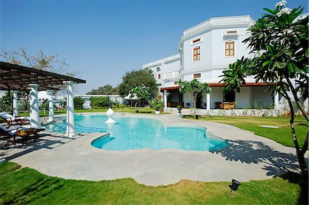 simsearch:862-08273264,k - India, Andhra Pradesh, Hyderabad. The gardens and private swimming pool of the Grand Presidential Suite at the Falaknuma Palace Hotel. Stock Photo - Rights-Managed, Code: 862-06541936
