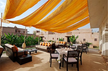 simsearch:862-08273264,k - India, Rajasthan, Nagaur. The informal al fresco dining terrace of Ranvas, a luxury hotel occupying part of Ahichhatragarh Fort. Stock Photo - Rights-Managed, Code: 862-06541967