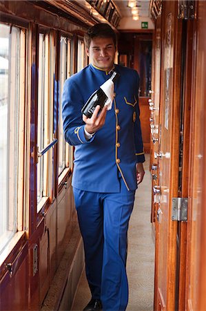 Uniformed Orient Express attendant with steam locomotive Stock Photo - Alamy