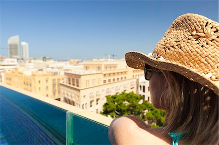 simsearch:862-07910882,k - Lebanon, Beirut. A woman looks out over Beirut from the rooftop pool of the Le Gray Hotel. MR. Stock Photo - Rights-Managed, Code: 862-06542337