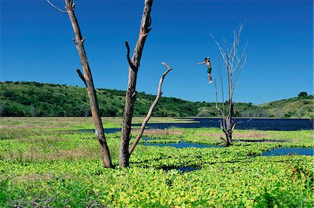 simsearch:862-06542611,k - Boy jumping into lake Lagune, Nicaragua, Central America Foto de stock - Con derechos protegidos, Código: 862-06542537