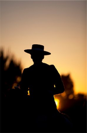 simsearch:614-08126754,k - Seville, Andalusia, Spain. Silhouette of Horse riders on their way to the village of El Rocio during the El Rocio pilgrimage Stock Photo - Rights-Managed, Code: 862-06542963