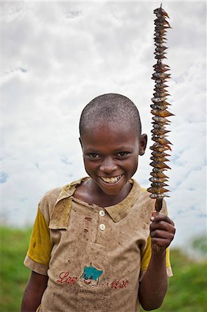 A young boy proudly displays his catch of the day from Lake Mutanda, Uganda, Africa Foto de stock - Con derechos protegidos, Código: 862-06543272