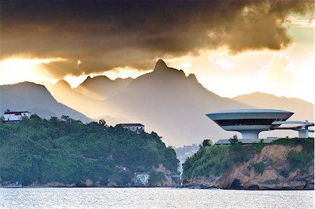 South America, Rio de Janeiro, Niteroi, Oscar Niemeyers Contemporary Art Museum, MAC Niteroi, set against the dramatic mountains of Rio de Janeiro city Stock Photo - Rights-Managed, Code: 862-06675764