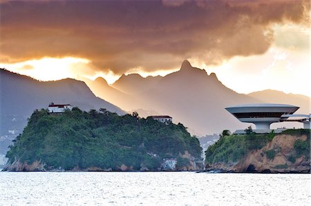 South America, Rio de Janeiro, Niteroi, Oscar Niemeyers Contemporary Art Museum, MAC Niteroi, set against the dramatic mountains of Rio de Janeiro city Stock Photo - Rights-Managed, Code: 862-06675763