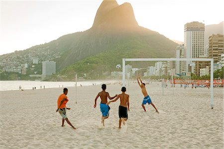 South America, Rio de Janeiro, Rio de Janeiro city, Ipanema, boys playing football on Ipanema beach in front of the Dois Irmaos mountains Stock Photo - Rights-Managed, Code: 862-06675793