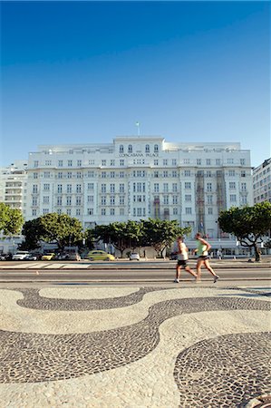 simsearch:862-06675980,k - Copacabana Palace Hotel, Avenida Atlantica, Copacabana Beach, joggers in front of the Copacabana Palace hotel with the black and white Portuguese paving on the sidewalk in the foreground Stock Photo - Rights-Managed, Code: 862-06675803