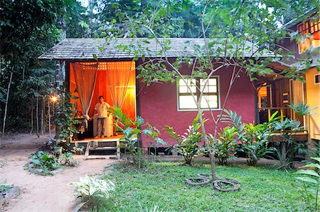 south america jungle pictures - Brazil, Amazon, Acre state, Xapuri, Reserva Extrativista Chico Mendes, Rubber tapper standing in the door to the kitchen at the ecotourism resort and jungle lodge of Seringal Cachoeira in the Amazon tropical forest Stock Photo - Rights-Managed, Code: 862-06675844