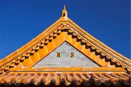 Architectural detail of the yellow glazed ceramic roof tiles, gable and eaves of the Gate of Supreme Harmony, the Forbidden City, Beijing, China. Stock Photo - Rights-Managed, Code: 862-06676153