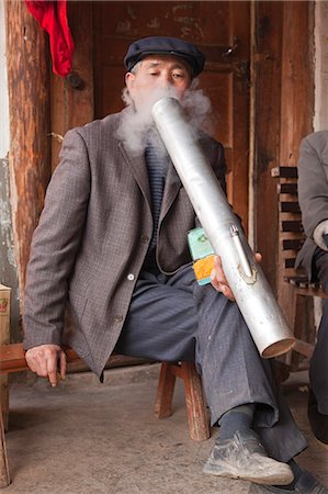 simsearch:862-03807589,k - China, Yunnan, Luoping. An elderly man smoking a water pipe. Stock Photo - Rights-Managed, Code: 862-06676188