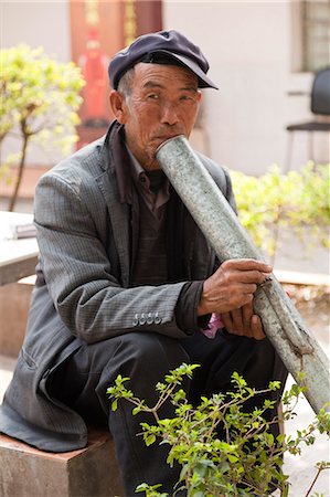 pipe smoking - China, Yunnan, Xinping. An elderly man enjoying a peaceful smoke. Stock Photo - Rights-Managed, Code: 862-06676235