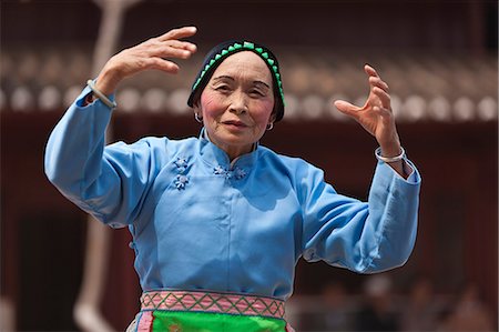 simsearch:862-06676338,k - China, Yunnan, Liuyi. An elderly lady dancing in the village of Liuyi. Stock Photo - Rights-Managed, Code: 862-06676251