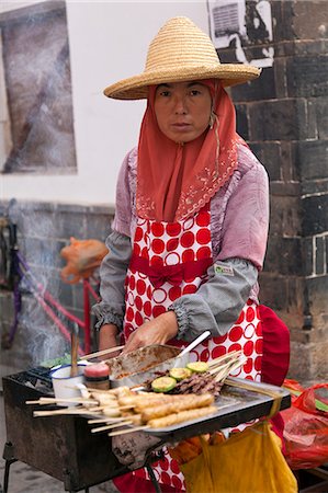 street vendor china - China, Yunnan, Jianshui. A street trader selling hot snacks in Jianshui. Stock Photo - Rights-Managed, Code: 862-06676278