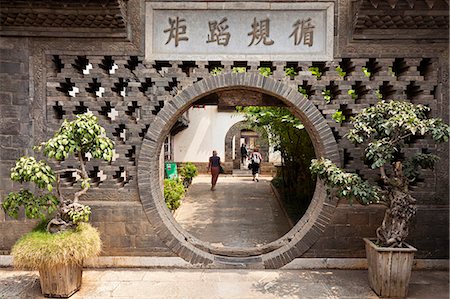 China, Yunnan, Jianshui. A moon gate at the Zhu Family Garden Hotel, an old Chinese mansion dating back to the Qing Dynasty, in Jianshui. Stock Photo - Rights-Managed, Code: 862-06676270